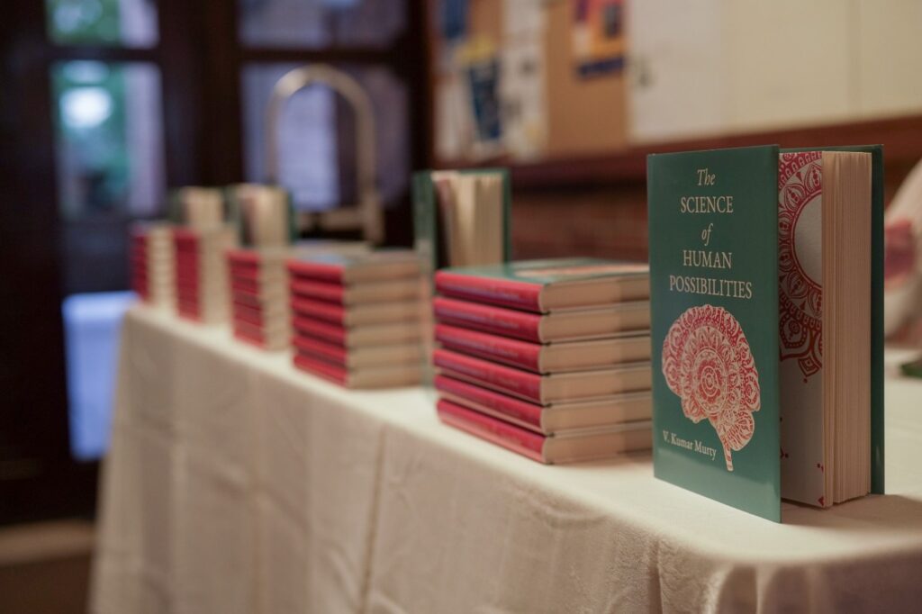 Copies of "The Science of Human Possibilities" by Kumar Murty stacked on a table ready for sale at his book launch.  